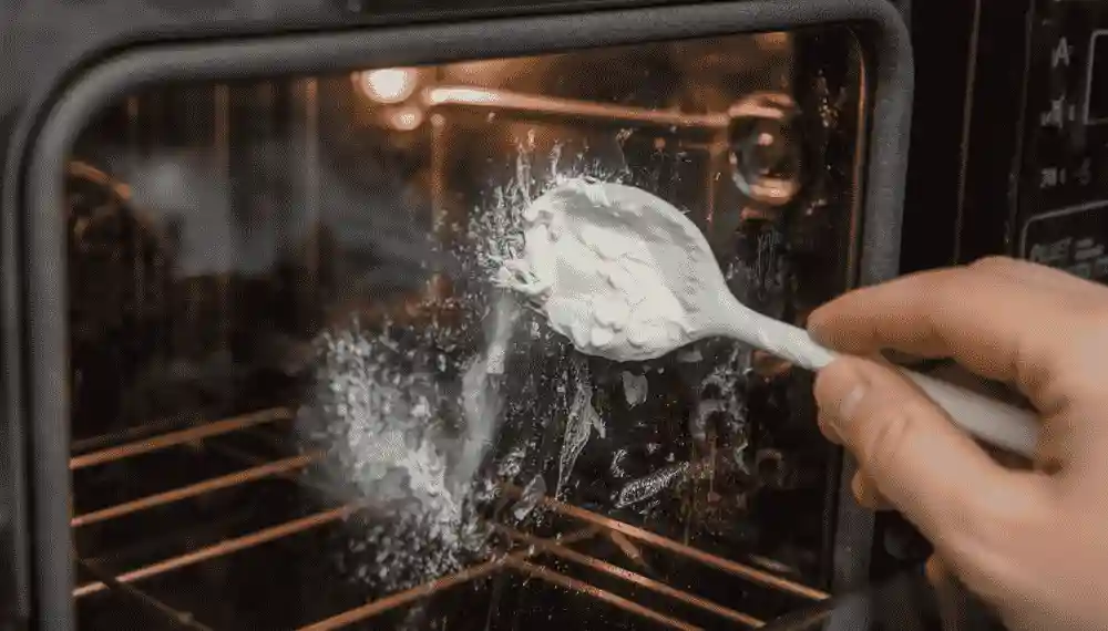 baking soda paste applied to the inside of a toaster oven glass door to lift grease stains